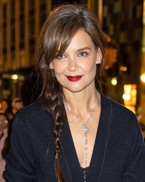 Katie Holmes wearing a braid and dark cardigan